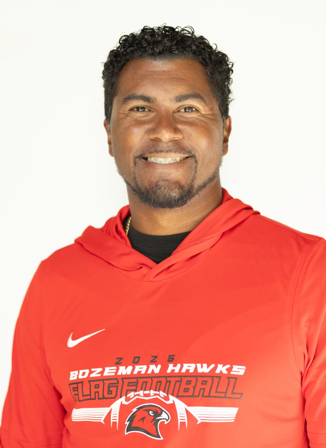 Evin Groves, FLAGWARE founder, wearing a Bozeman Hawks flag football hoodie